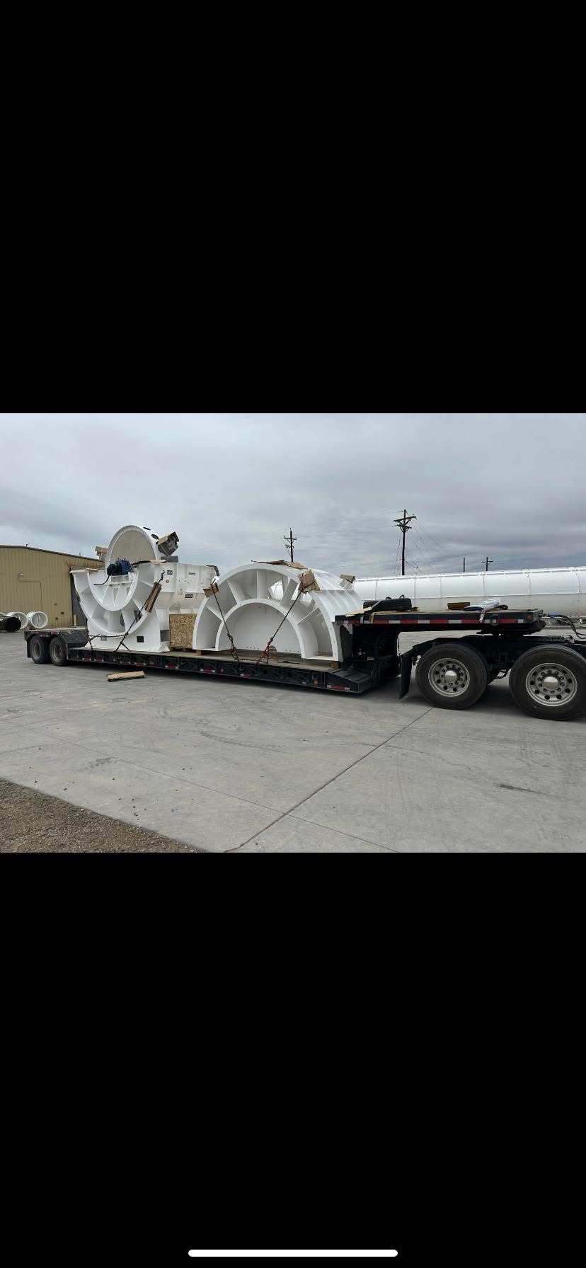 Lowboy trailer hauling heavy industrial steel pipe for US-Mexico freight support