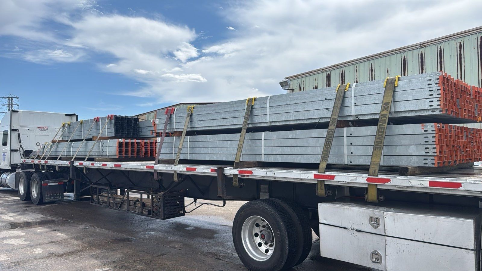 Flatbed freight truck moving an active load on a Texas highway lane
