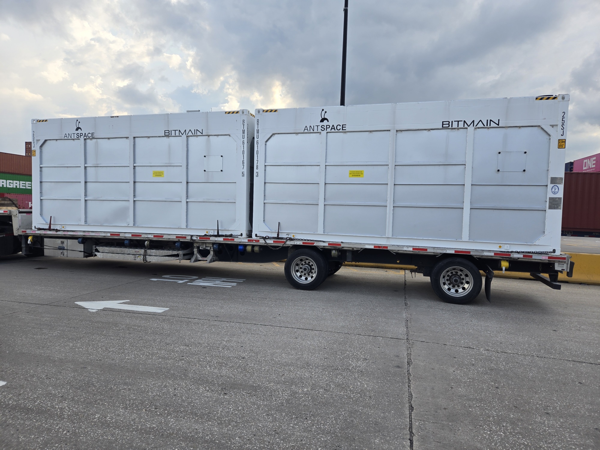 Flatbed loaded with crates staged for cross-border port freight coordination