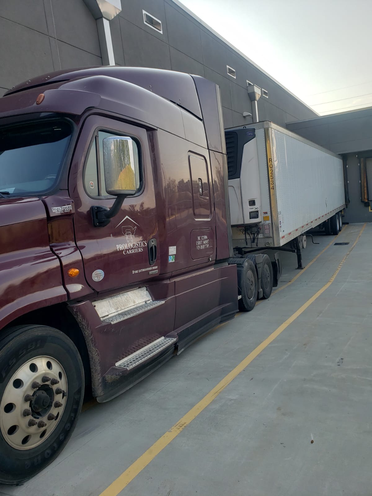 Freight trucks staged at a warehouse dock for last-mile delivery coordination