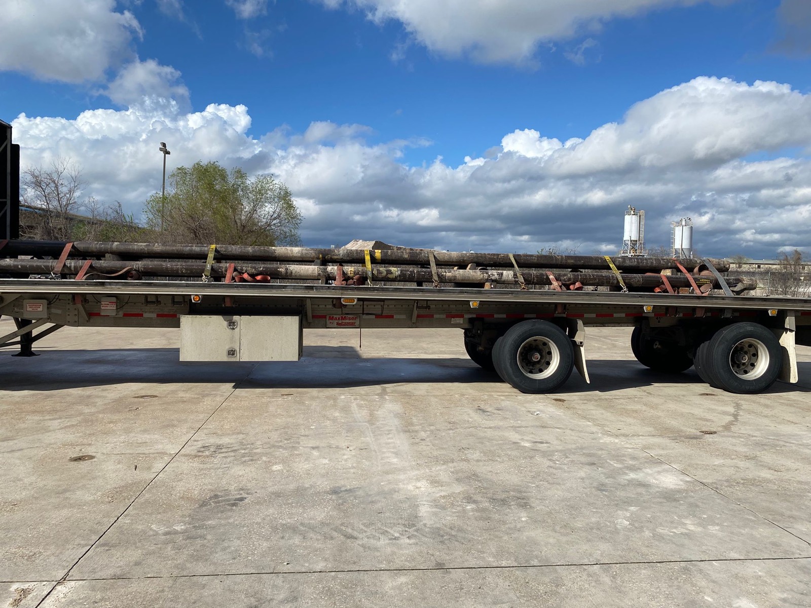 Large-diameter pipe strapped on a flatbed